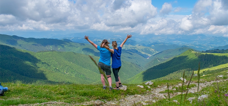 two women enjoying the view over Romanian mountains